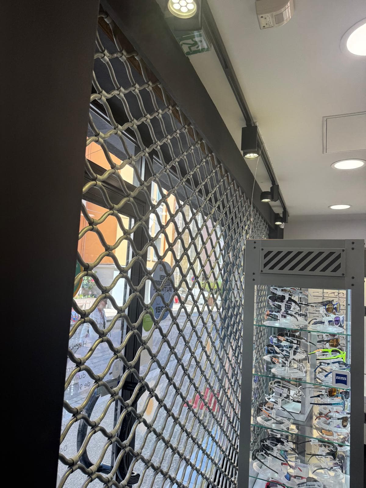 Changement de moteur sur grille métallique à tubes ondulés chez un opticien à Annecy